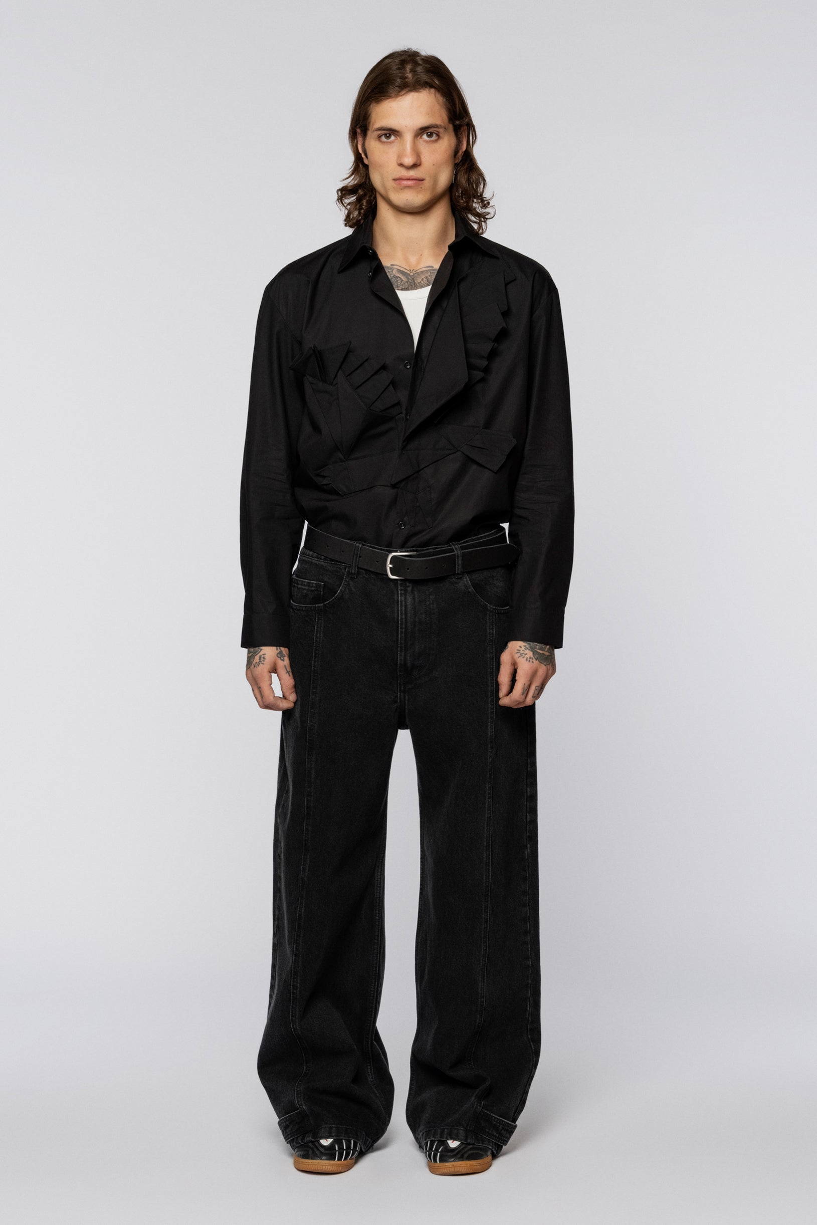 Black wide jeans with a washed effect and snap fasteners at the hem