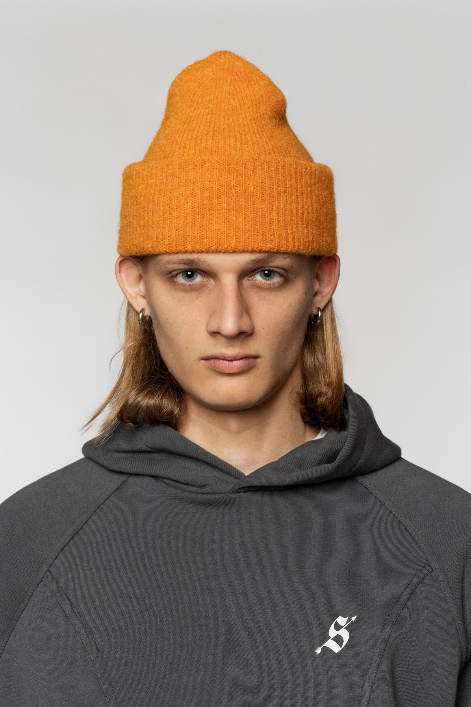 Knitted Fluffy hat from textured yarn in orange