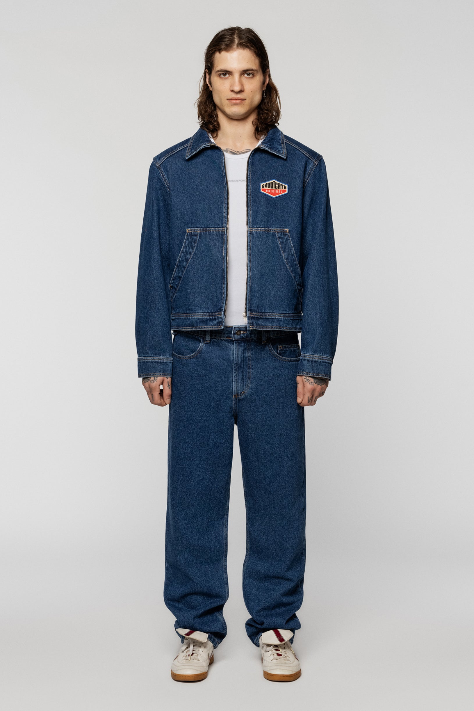 Blue denim jacket with a Syndicate patch