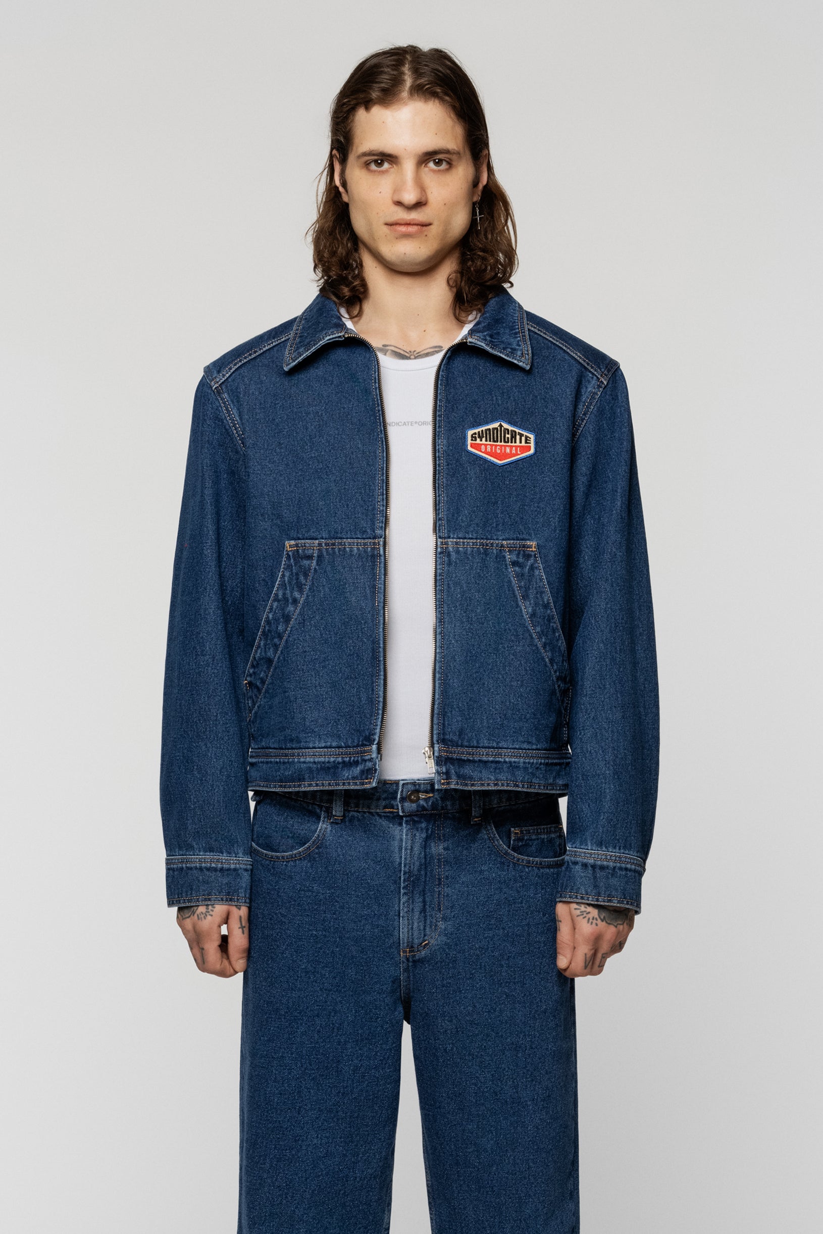 Blue denim jacket with a Syndicate patch