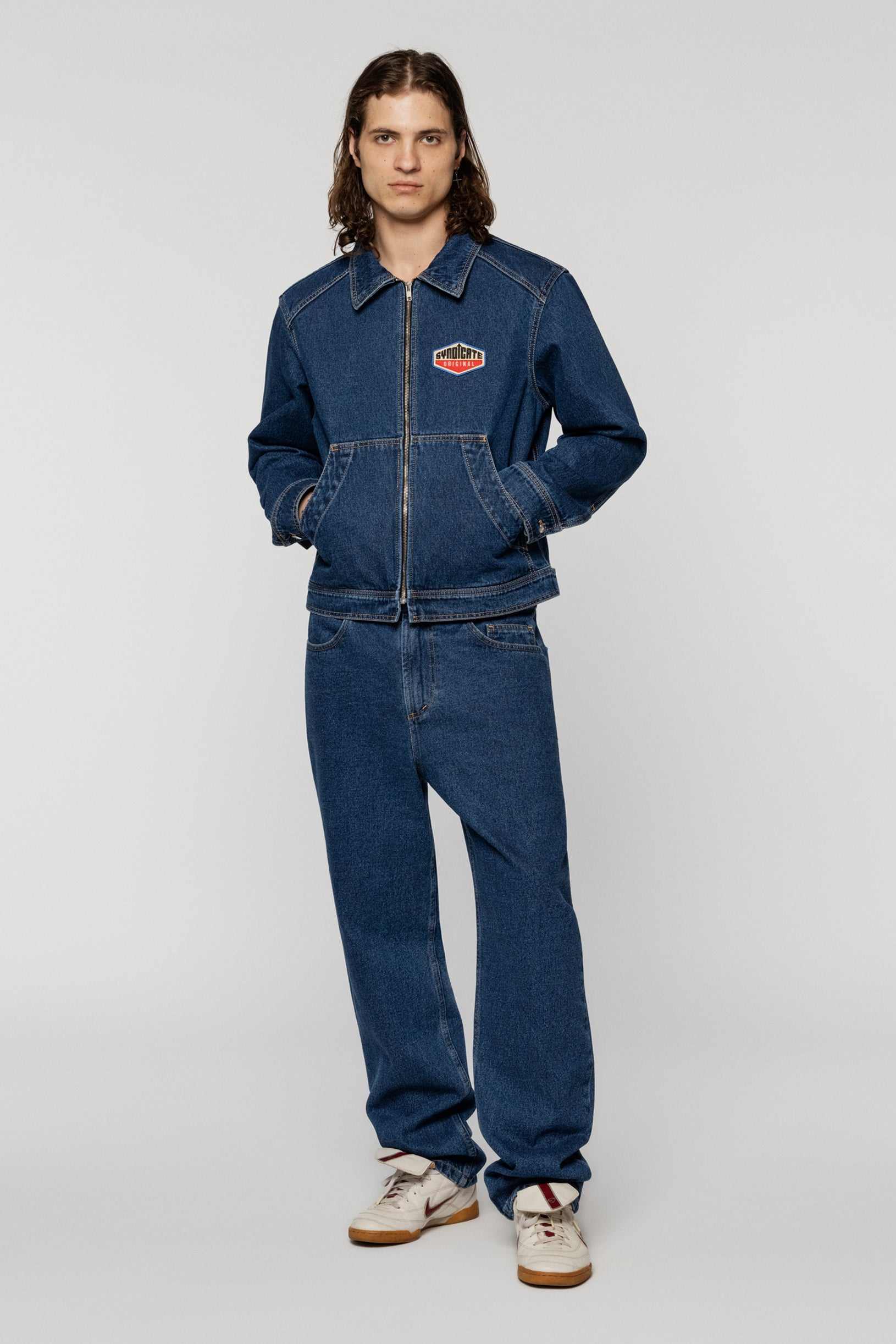 Blue denim jacket with a Syndicate patch