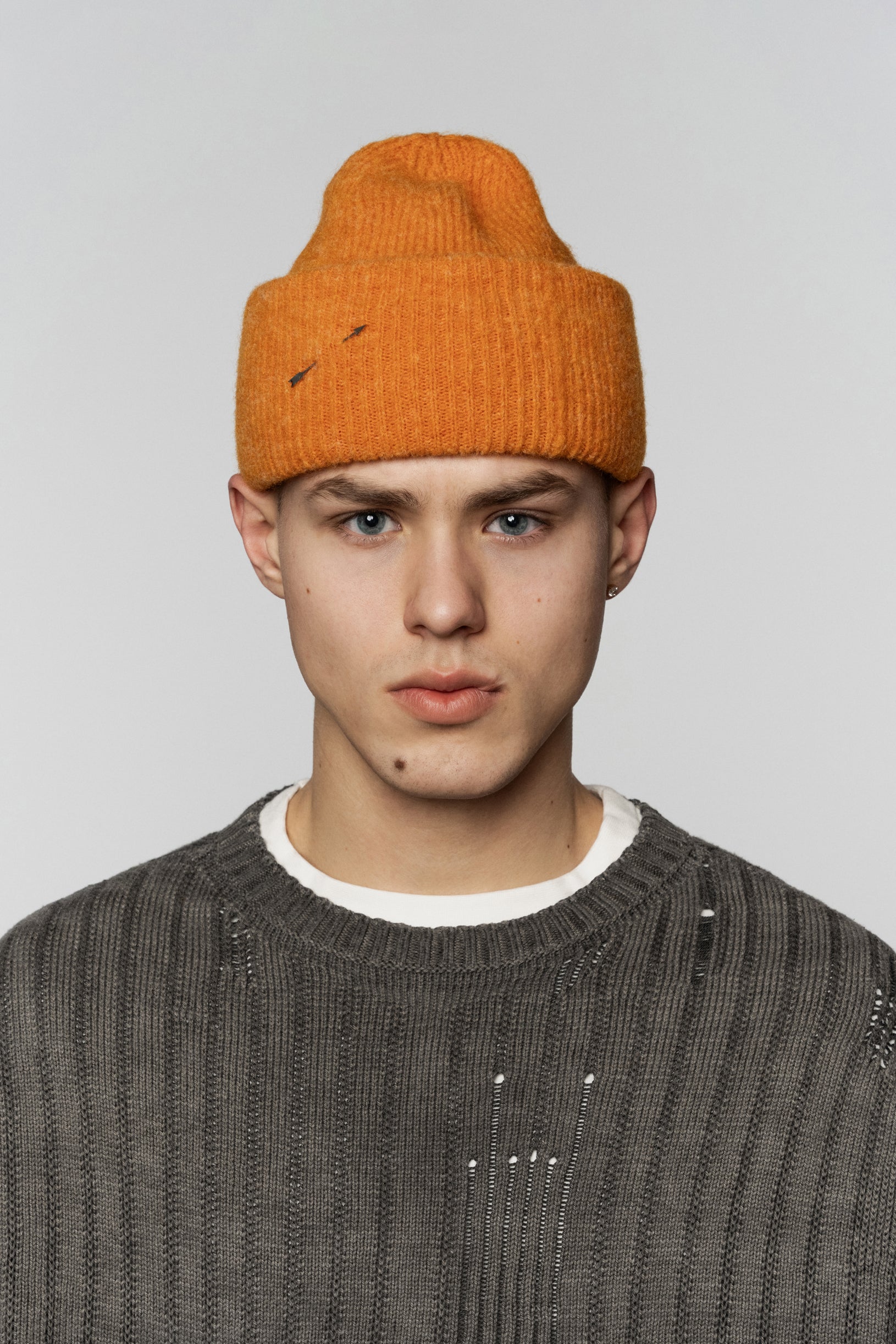 Knitted Fluffy hat from textured yarn in orange