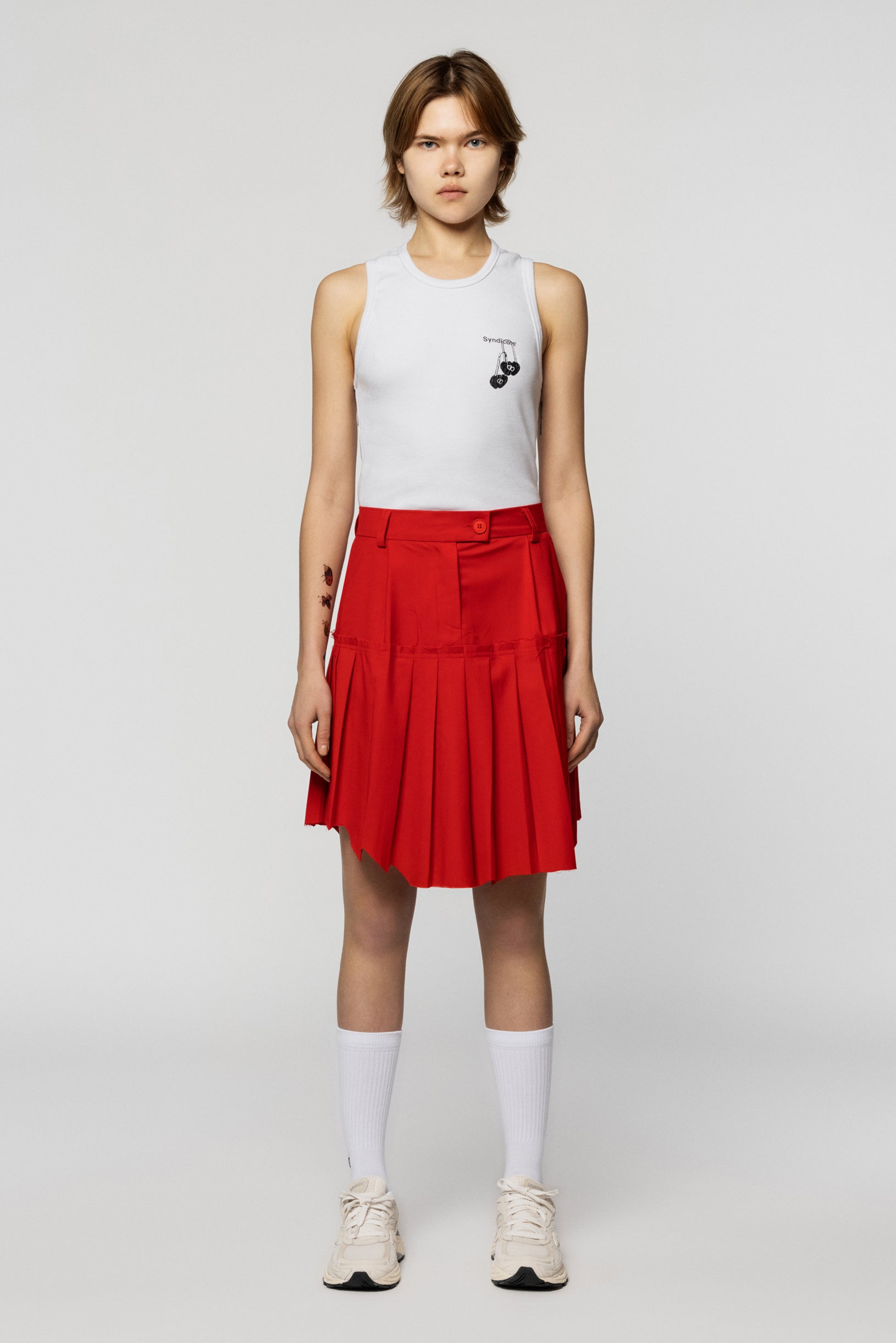 Pleated red skirt by Raw School with a raw edge