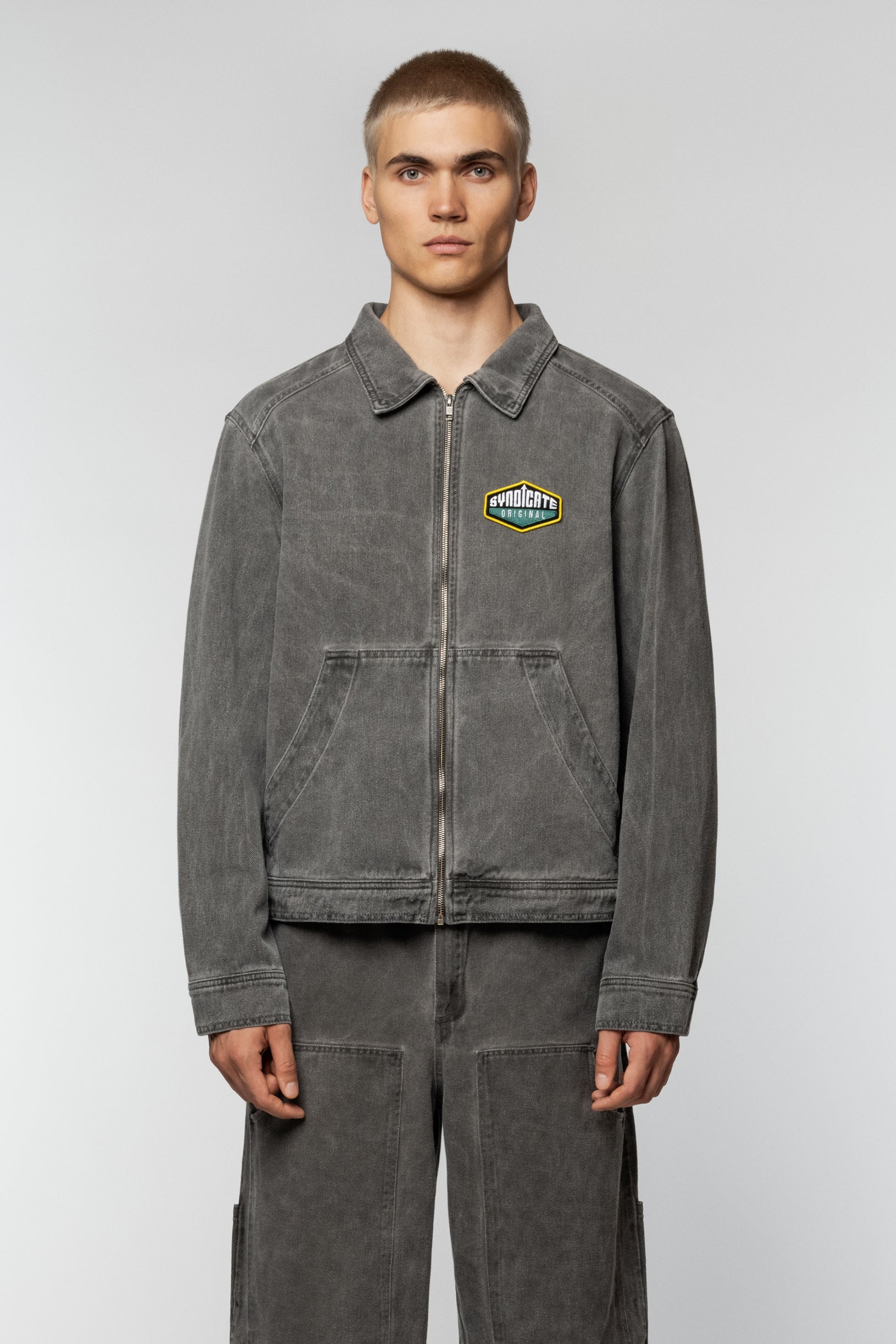 Unisex grey denim jacket by Syndicate with a straight cut