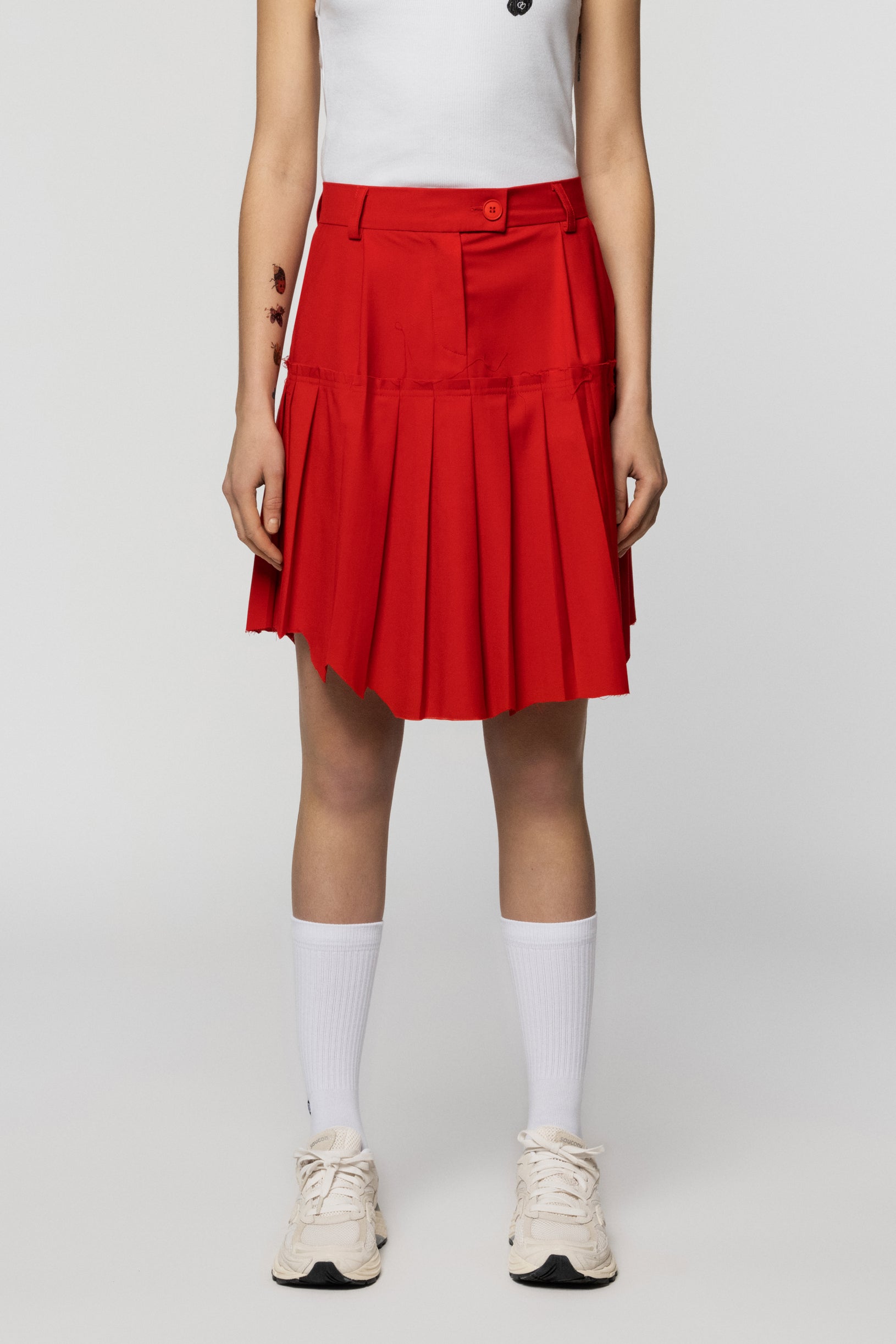 Pleated red skirt by Raw School with a raw edge